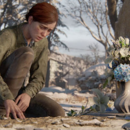 Ellie en train de fleurir la tombe d'un proche, dans The Last of Us Part II.